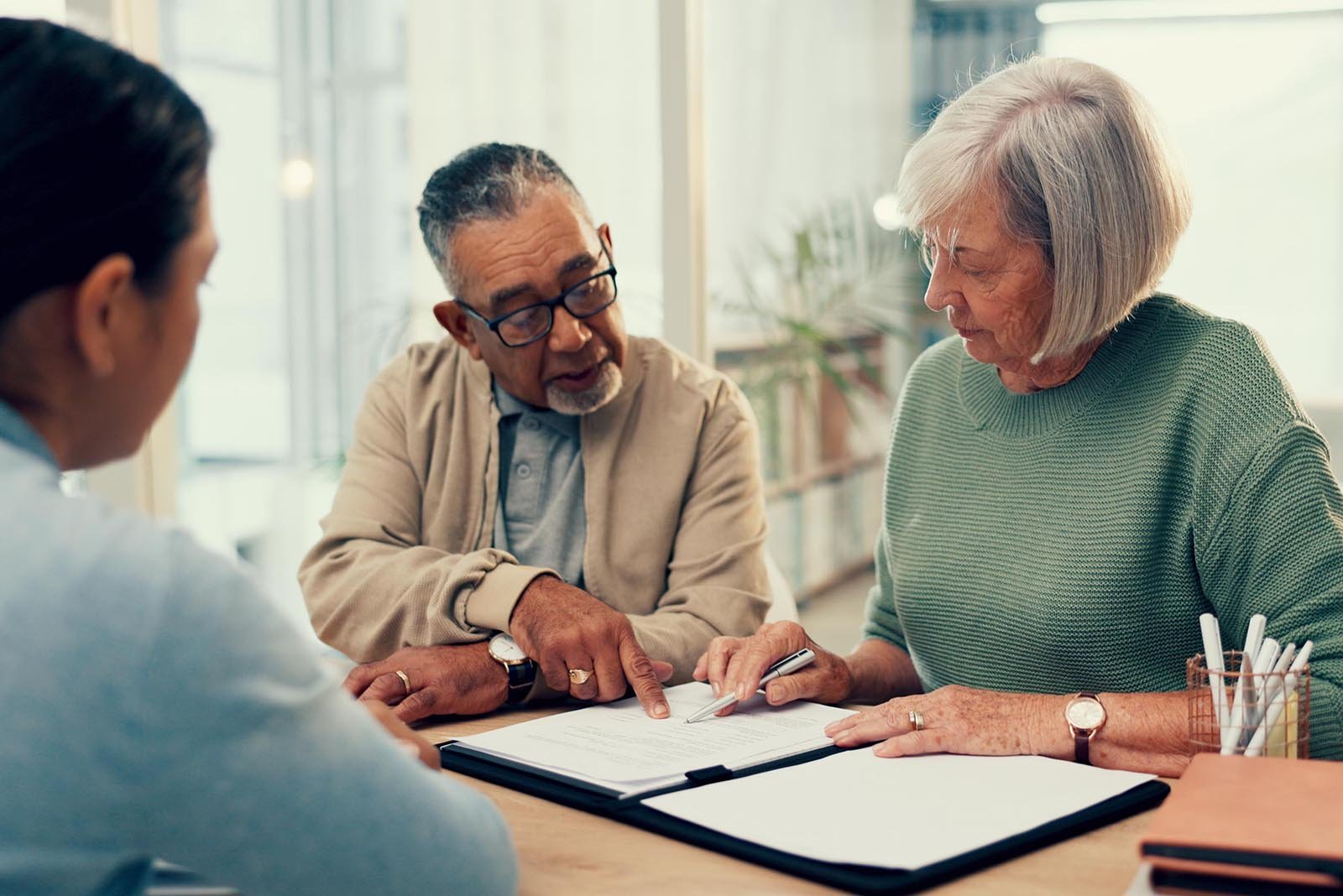 Office, lawyer or old couple with will, contract or document for retirement funding or compliance. Plan, advisor or married elderly clients with legal form or title deed agreement with life insurance.