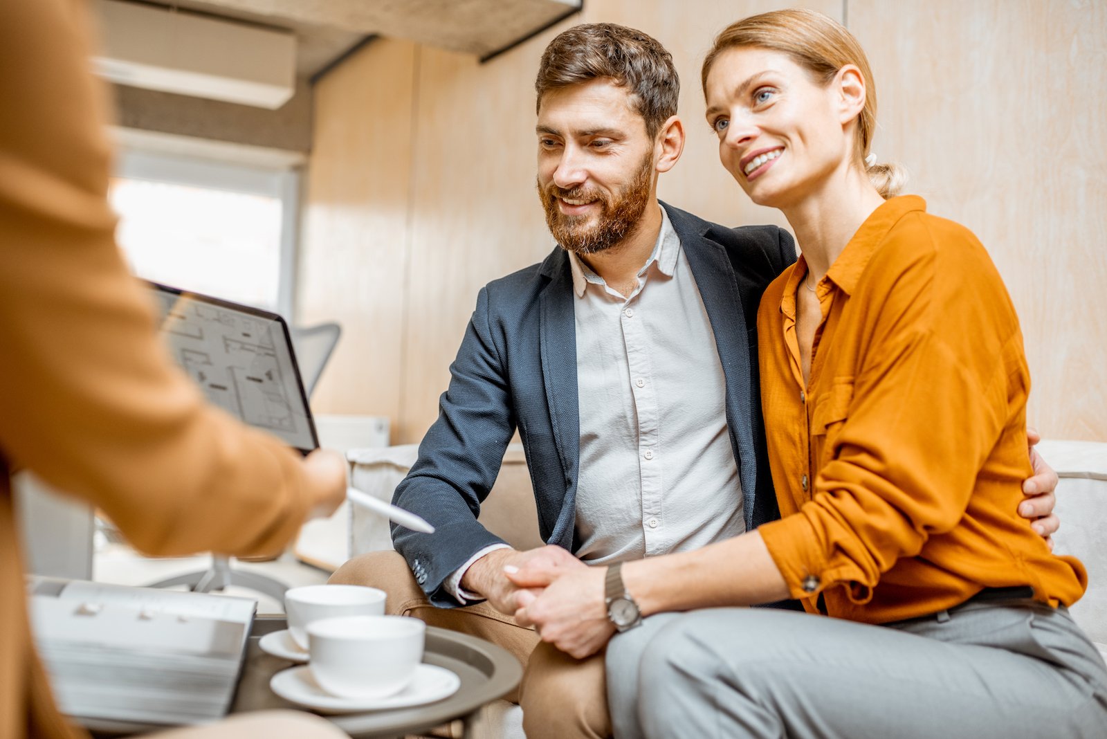 young-couple-choosing-house-at-the-real-estate